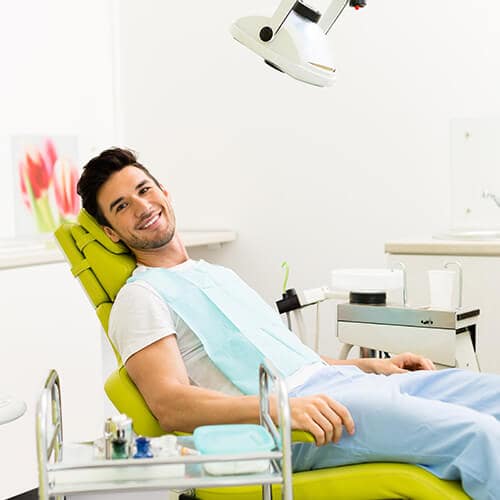 A young man lying relaxed in a dental treatment chair after receiving sedation dentistry in Bellevue, WA to help him relax. 